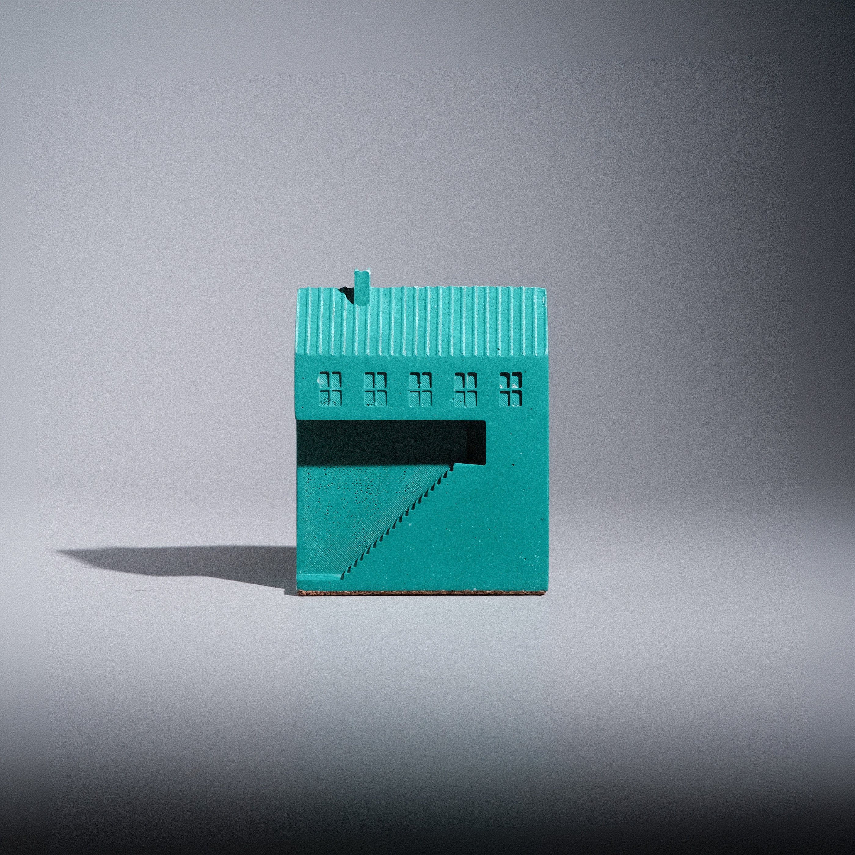 Kaidan Paperweight side view, Jesmonite house-shaped paperweight with roofline and chimney, Kuro Design
