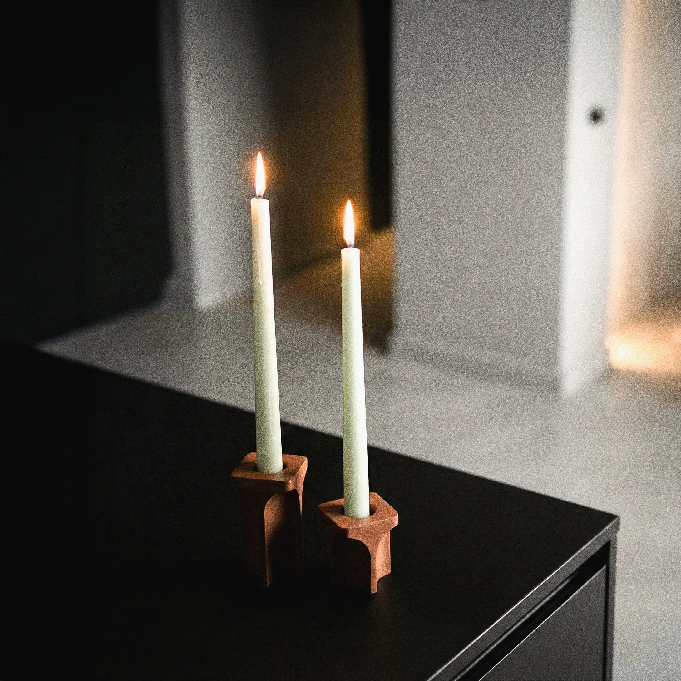 Kuro Design Kiva Candle Holder with candle flame in soft ambient light — Jesmonite