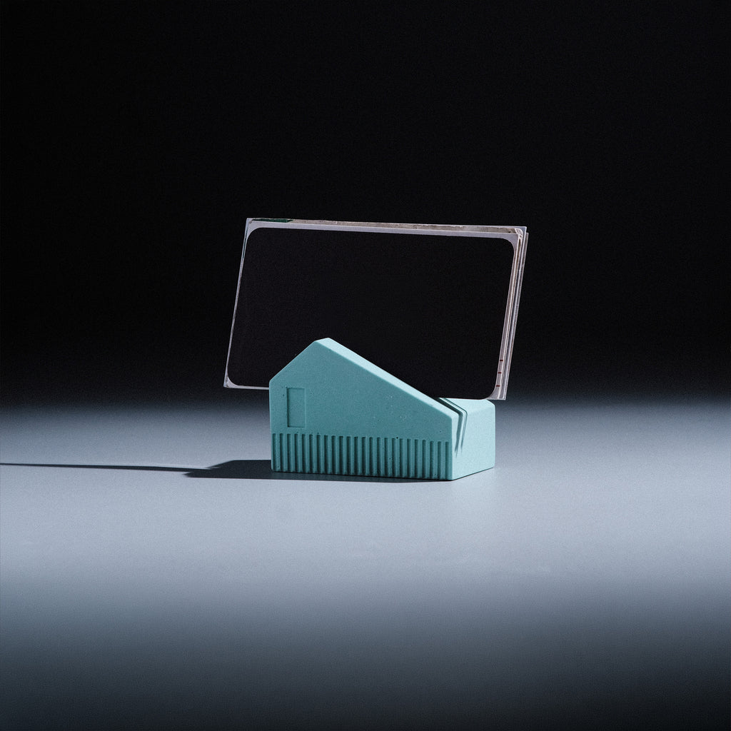 Koya Card Stand by Kuro Design holding business cards at a natural angle, minimal Jesmonite desk accessory made in India