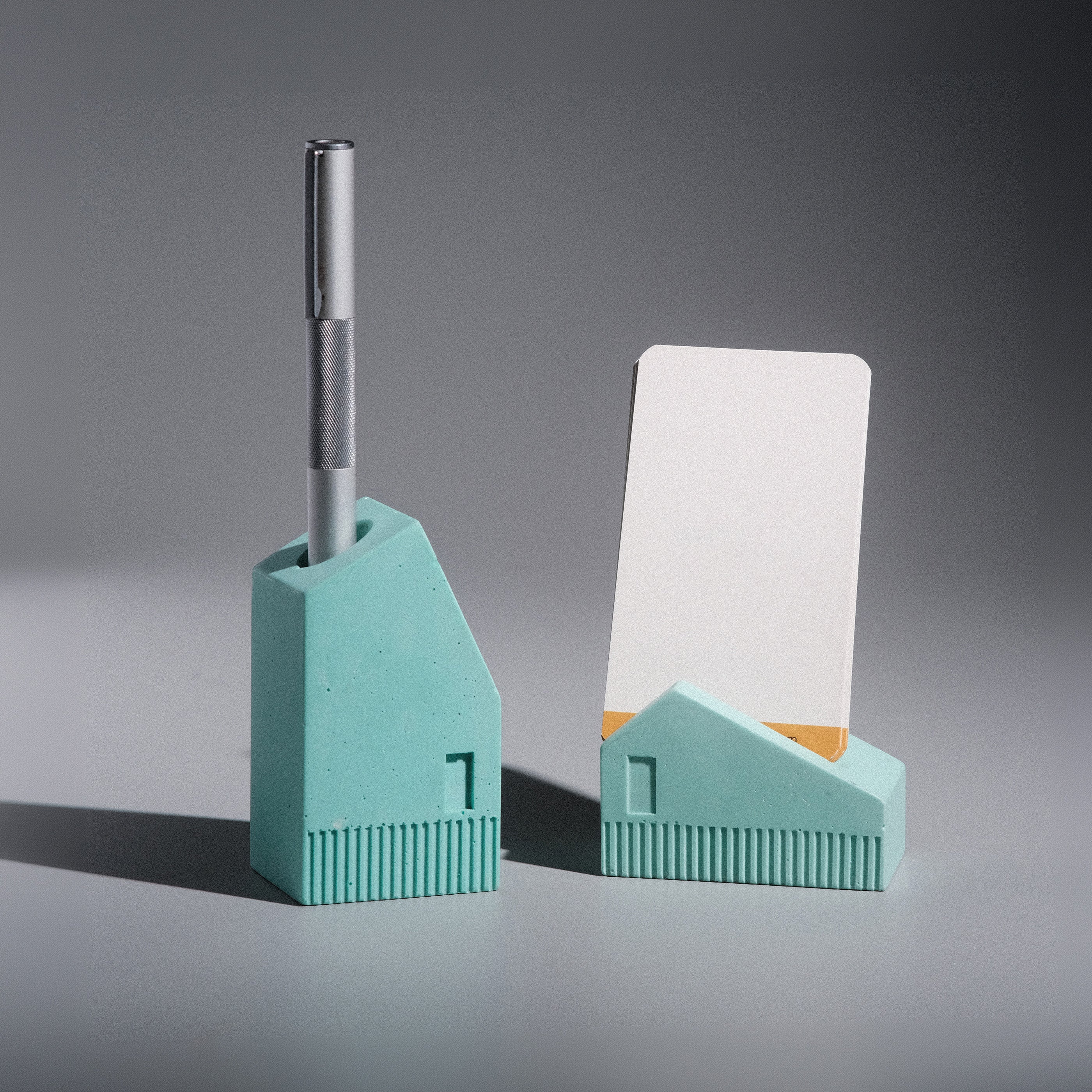 Kuro Design Koya Pen and Card Stand set, two handcrafted Jesmonite houses that hold a pen and business cards