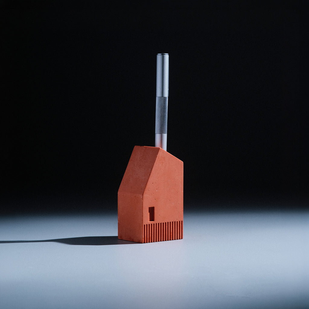Koya Pen Stand detail showing the ribbed base and small window cutout in terracotta Jesmonite, by Kuro Design