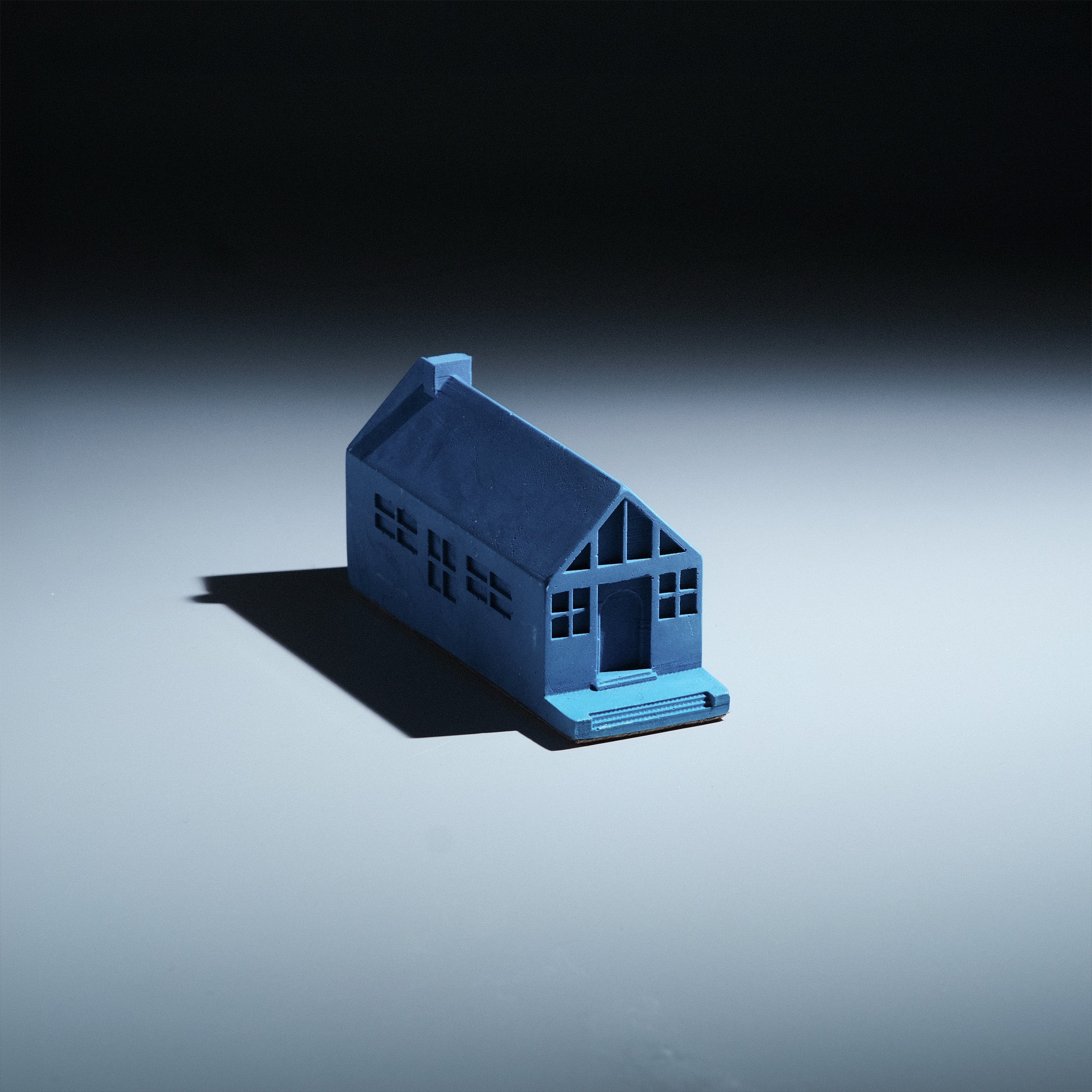 Mado Paperweight by Kuro Design, Jesmonite house with arched doorway and slit windows, made in Gurgaon India