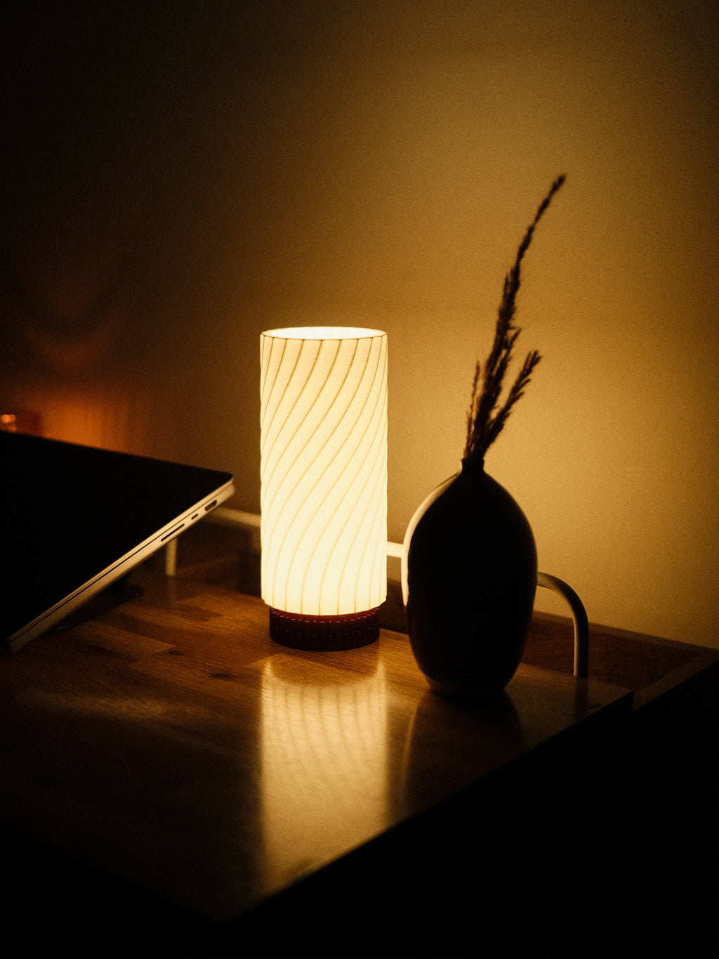 Mizuki desk lamp by Kuro Design creating ambient light in a home office setting