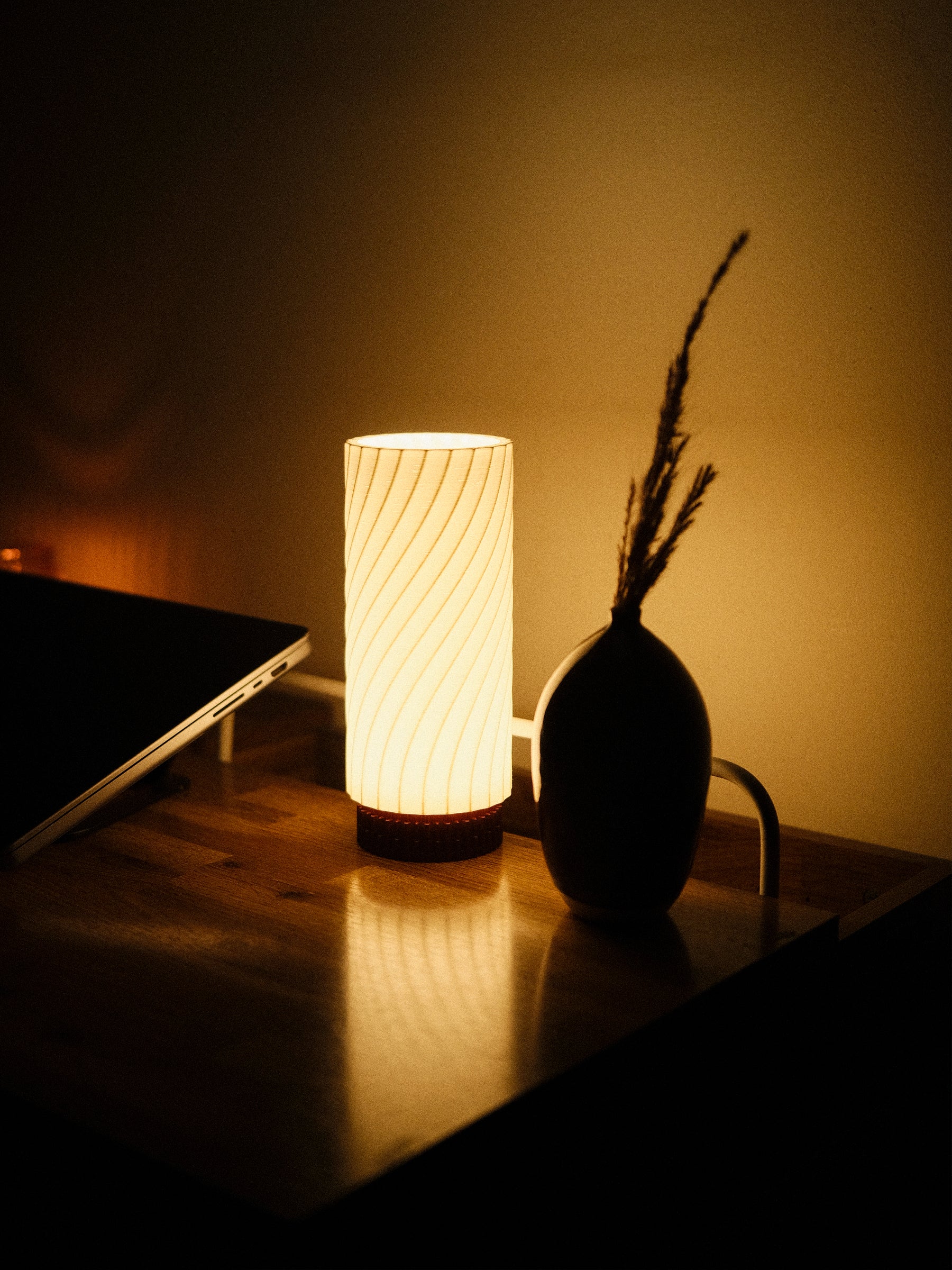 Mizuki desk lamp by Kuro Design creating ambient light in a home office setting