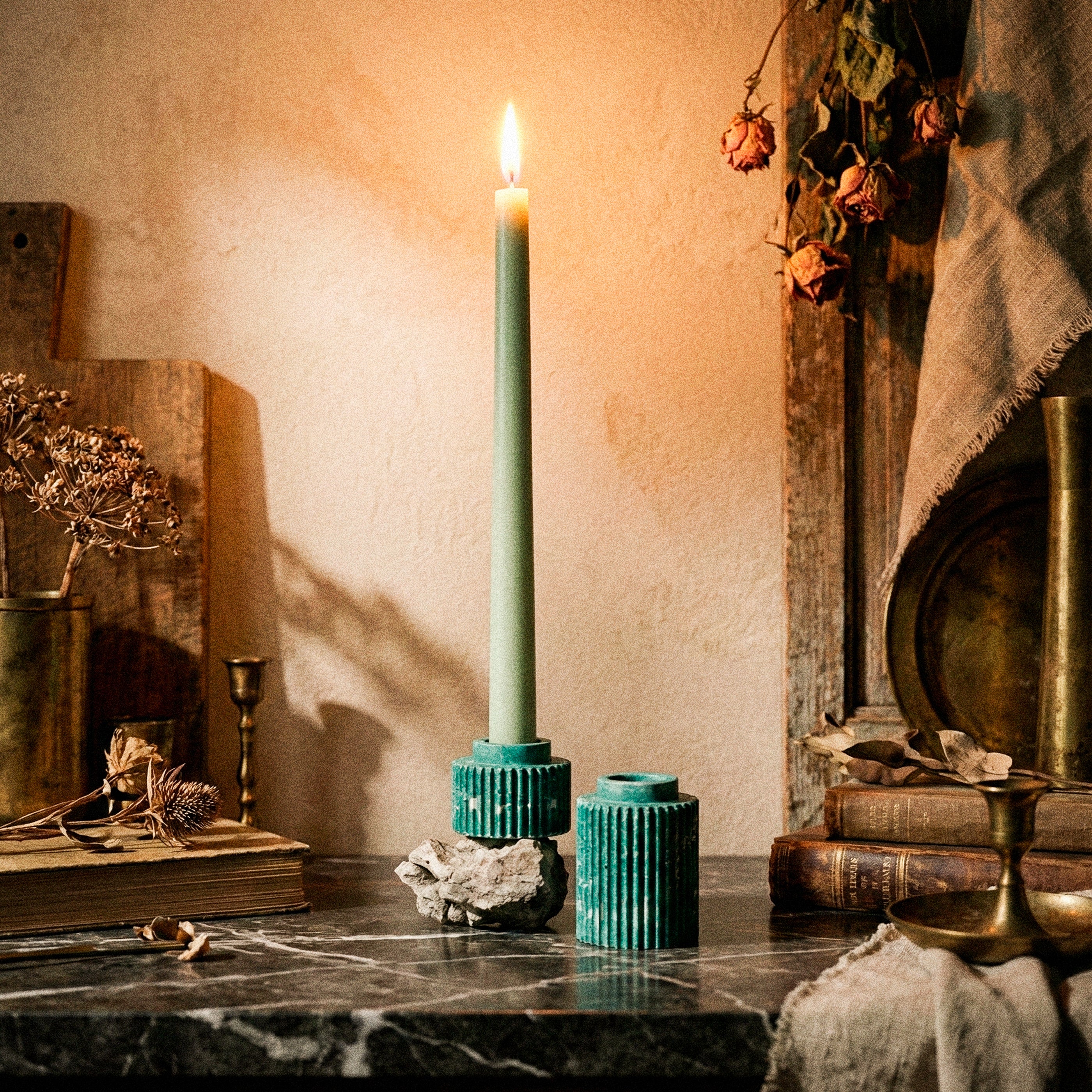 Seki Candle Holder by Kuro Design with candle lit on a warm minimal desk setup